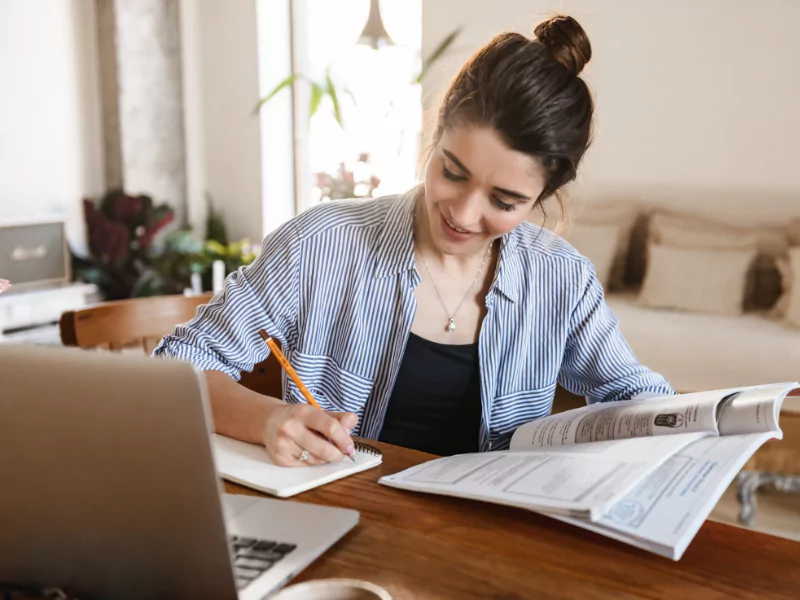 The girl is completing her academic work  and trying to complete them before time<br />
