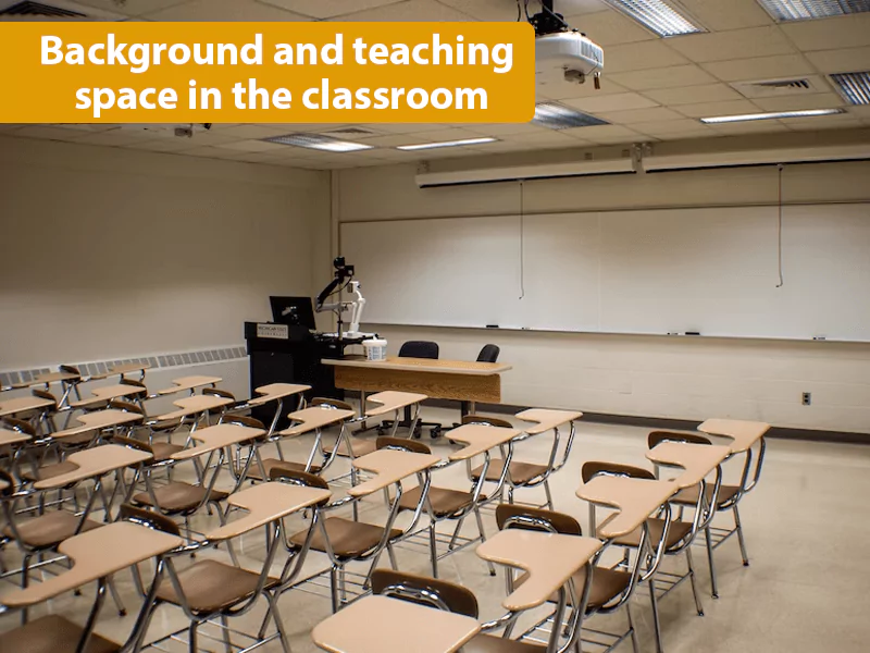 The image shows a classroom with many chairs to sit and a blackboard. It talks about Background and teaching space in the classroom The image shows a classroom with many chairs to sit and a blackboard. It talks about Background and teaching space in the classroom