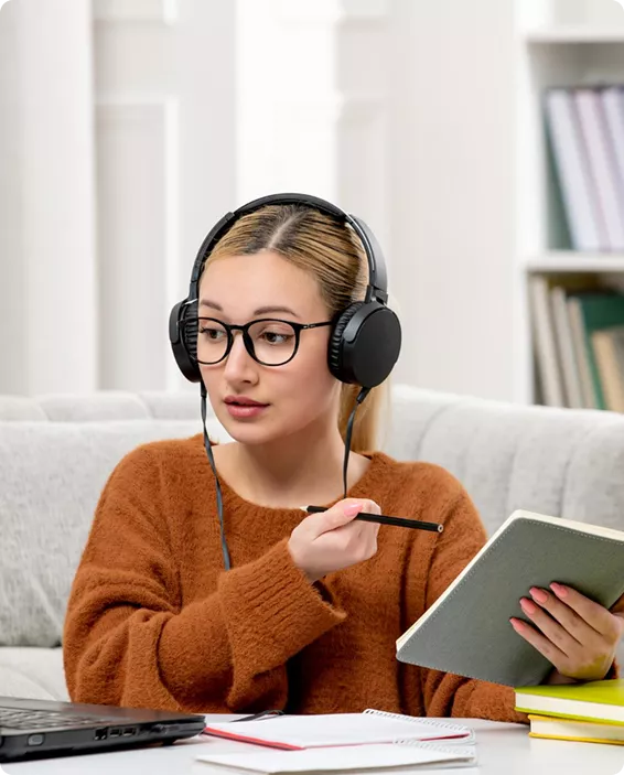 Young woman engaged in remote learning at a desk, illustrating a reliable take my online class assistance service.